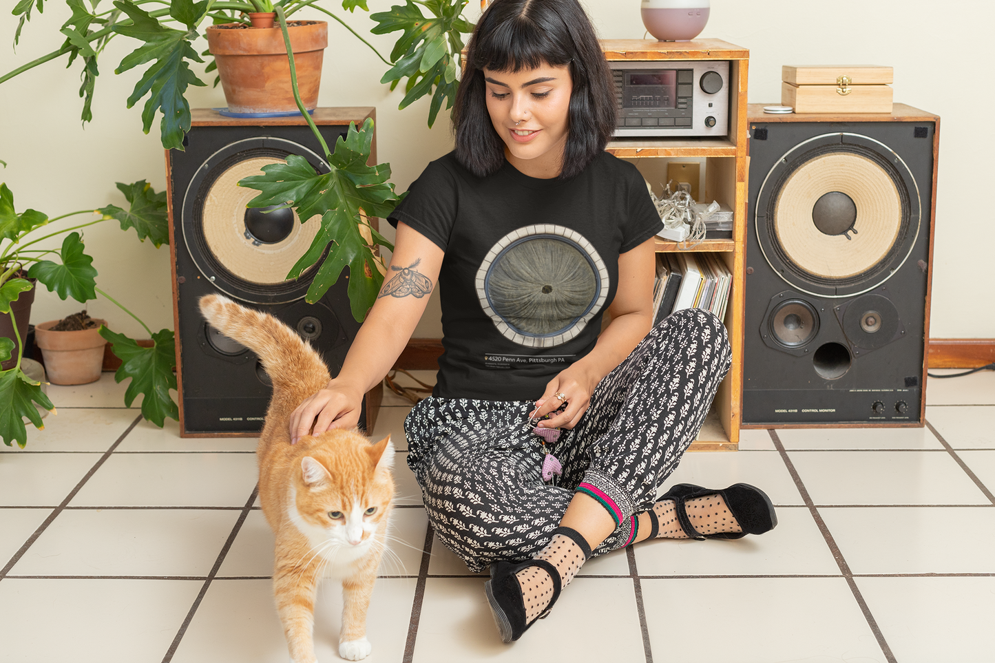 A woman wearing a Butthole Window Unisex Softstyle T-Shirt